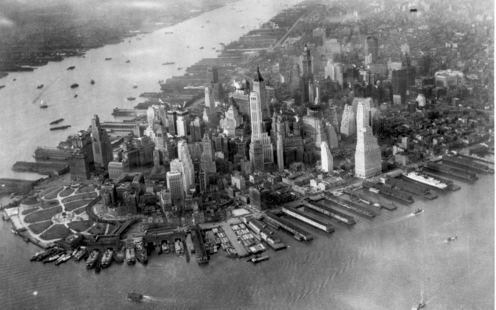 Aerial view of lower Manhattan's skyline surrounded by piers and harbor traffic