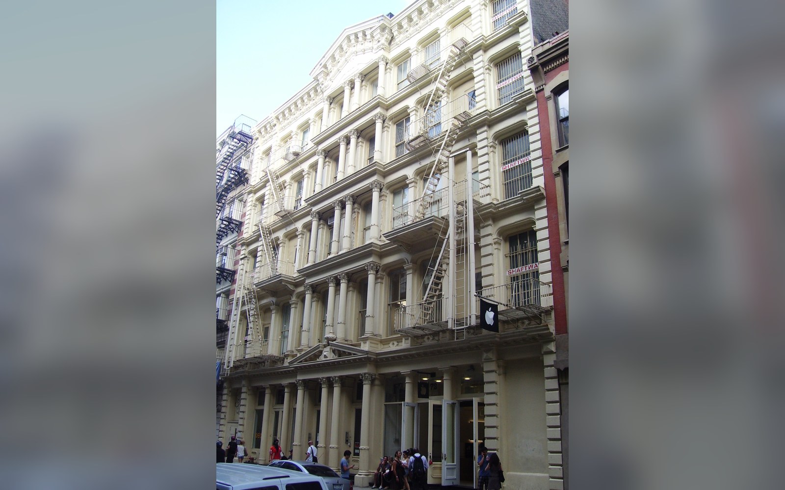 Cast-iron facade building with fire escapes and ground-floor Apple Store entrance